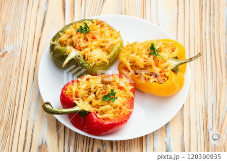 Baked stuffed pepper ( paprika ) with rice , carrot and meat . Top view on rustic background Baked stuffed pepper ( paprika ) with rice , carrot and meat . Top view on rustic background 120390935