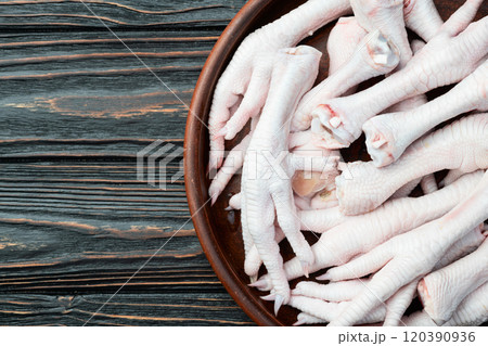 Raw chicken foot ( paws ) Top view on rustic background Raw chicken foot ( paws ) Top view on rustic background 120390936