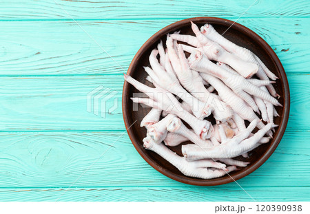 Raw chicken foot ( paws ) Top view on rustic background Raw chicken foot ( paws ) Top view on rustic background 120390938