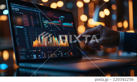 Analyzing financial data on laptop with charts 120392256