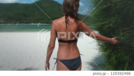 Young woman in bikini walking Malibu beach, Thailand, Koh Phangan Island. Female back view enjoy seascape and white sand shore landscape. Relax, outdoor lifestyle travel, summer holiday vacation Young woman in bikini walking Malibu beach, Thailand, Koh Phangan Island. Female back view enjoy seascape and white sand shore landscape. Relax, outdoor lifestyle travel, summer holiday vacation 120392496