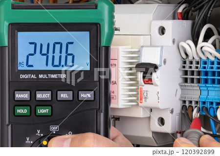 Voltage Measurement with Digital Multimeter in Electrical Panel 120392899