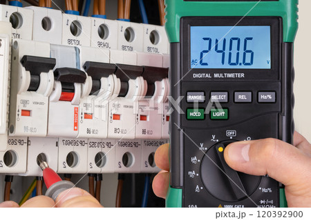 Electrician Testing Circuit Breaker with Multimeter Electrician Testing Circuit Breaker with Multimeter 120392900