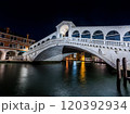 Nighttime Illumination of the Rialto Bridge Over the Grand Canal in Venice 120392934
