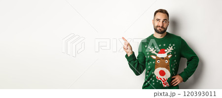 Winter holidays and christmas. Thoughtful bearded man thinking, having an idea and pointing finger at upper left corner, white background 120393011