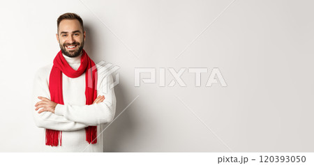 Christmas holidays and celebration concept. Handsome bearded man in sweater celebrating new year, wearing red scarf and smiling, standing over white background Christmas holidays and celebration concept. Handsome bearded man in sweater celebrating new year, wearing red scarf and smiling, standing over white background 120393050