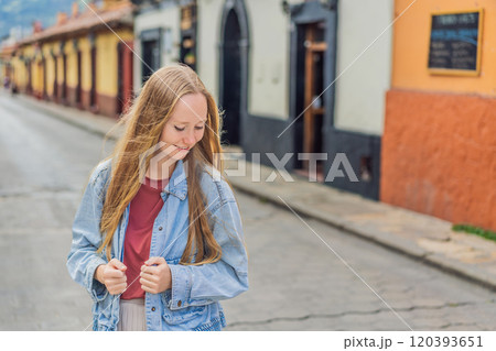 Female tourist walks through the colonial streets San Cristobal de las Casas, Mexico. Cultural exploration, architecture, and travel experience concept Female tourist walks through the colonial streets San Cristobal de las Casas, Mexico. Cultural exploration, architecture, and travel experience concept 120393651