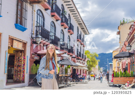 Female tourist walks through the colonial streets San Cristobal de las Casas, Mexico. Cultural exploration, architecture, and travel experience concept Female tourist walks through the colonial streets San Cristobal de las Casas, Mexico. Cultural exploration, architecture, and travel experience concept 120393825