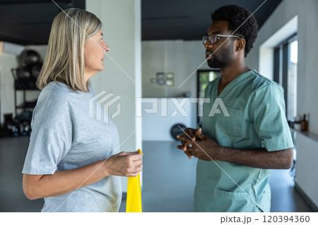 African american male doctor consulting a female patient with joints problems 120394360