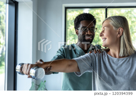 African american doctor having rehabilitation exercises with a female patient 120394399