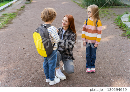 School-age kids in volunteer activity with teacher in park School-age kids in volunteer activity with teacher in park 120394659