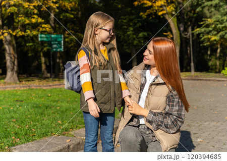 Camp teacher with little girl feeling great during happy walk in park Camp teacher with little girl feeling great during happy walk in park 120394685
