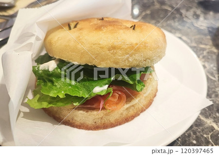 Smoked salmon bagel on white plate 120397465