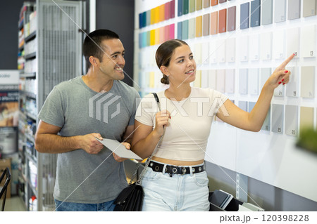Married couple chooses ceramic tiles for kitchen or bath at hardware store Married couple chooses ceramic tiles for kitchen or bath at hardware store 120398228