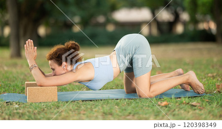 Adult woman doing yoga with blocks 120398349