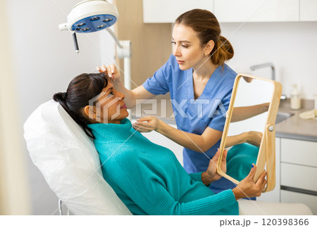 Woman having consultation at aesthetic medicine clinic Woman having consultation at aesthetic medicine clinic 120398366