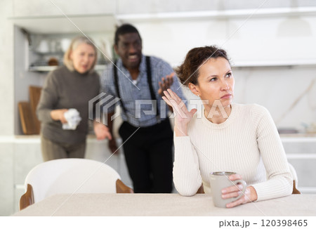 Woman not talking after disagreement with husband and mother standing behind Woman not talking after disagreement with husband and mother standing behind 120398465
