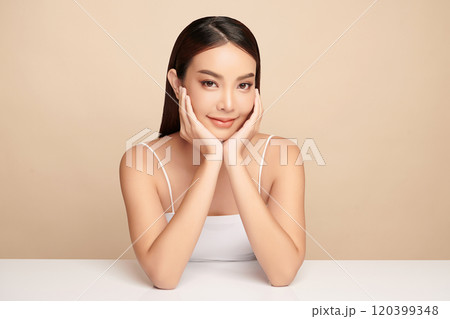 Beautiful young asian woman with clean fresh skin on beige background, Face care, Facial treatment, Cosmetology, beauty and spa, Asian women portrait. 120399348