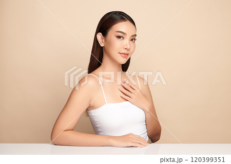 Beautiful young asian woman with clean fresh skin on beige background, Face care, Facial treatment, Cosmetology, beauty and spa, Asian women portrait. Beautiful young asian woman with clean fresh skin on beige background, Face care, Facial treatment, Cosmetology, beauty and spa, Asian women portrait. 120399351