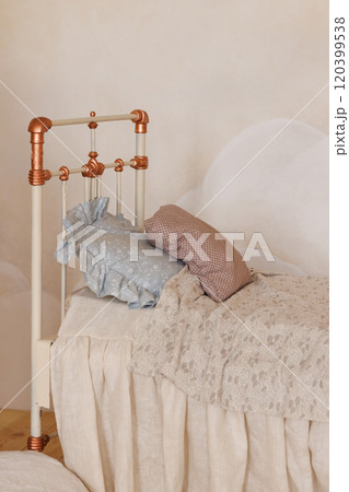 A bed with a white headboard and a blue pillow A bed with a white headboard and a blue pillow 120399538