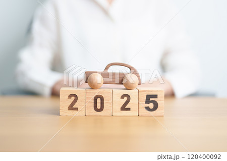 Happy New Year 2025 with Car model on table. Automobile Tax, Car Insurance, Financial, vehicle Repair and Maintenance and New Year concept 120400092