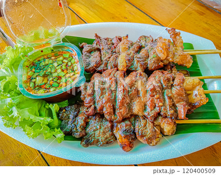 Grilled beef on skewers with spicy sauce, Grilled meat skewers. 120400509