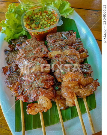 Grilled beef on skewers with spicy sauce, Grilled meat skewers. 120400513