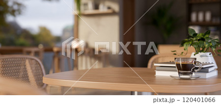 A close-up of a wooden table in a contemporary, cozy coffee shop. image with a copy space 120401066