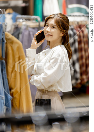 アパレル店でショッピングを楽しむ女性 120401455