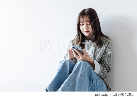 スマホを操作するハーフの若い女性 スマホを操作するハーフの若い女性 120404296