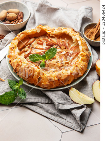 Delicious homemade apple galette with almond flakes and cinnamon Delicious homemade apple galette with almond flakes and cinnamon 120406424