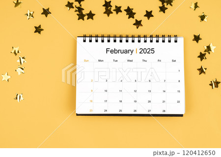 February 2025 calendar and scattered sparkling yellow confetti stars. February 2025 calendar and scattered sparkling yellow confetti stars. 120412650