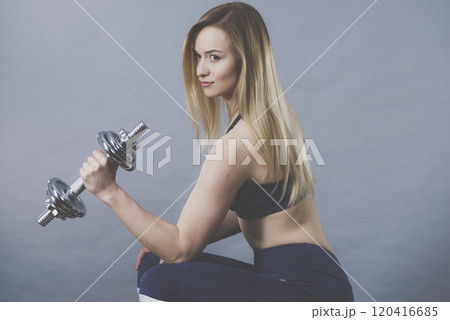Fit woman lifting dumbbells weights Fit woman lifting dumbbells weights 120416685