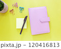 Pink Planner with Sticky Notes, Pen and Clips on Yellow Background 120416813