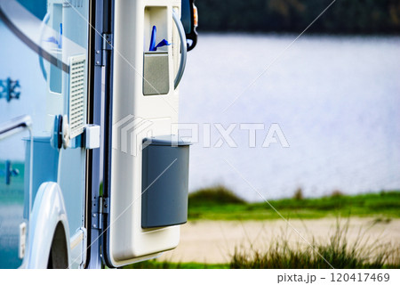 Camper on nature. Open door with trash can. 120417469