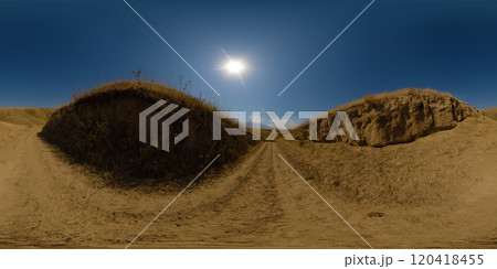 Spherical HDRi panorama of dry dirt road over dry grass hill at sunny autumn day with clear blue sky above Spherical HDRi panorama of dry dirt road over dry grass hill at sunny autumn day with clear blue sky above 120418455