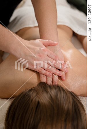 Therapist performing back massage with hands on a relaxed patient. Wellness and relaxation concept 120418607