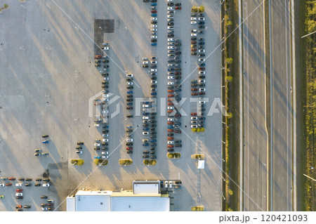 View from above of dealers outdoor parking lot with many brand new cars in stock for sale on highway side. Concept of development of american automotive industry View from above of dealers outdoor parking lot with many brand new cars in stock for sale on highway side. Concept of development of american automotive industry 120421093