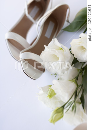 White wedding shoes with white flowers.  120421681