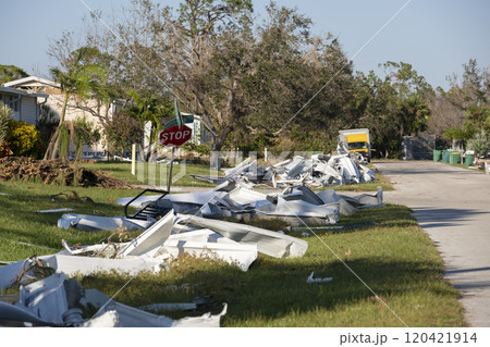 Metallic scrap rubbish on roadside from hurricane severely damaged houses in Florida residential area. Aftermath of natural disaster 120421914