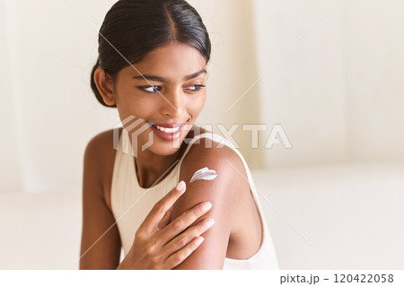 Smiling Woman Applying Skincare Cream for Smooth and Healthy Skin Smiling Woman Applying Skincare Cream for Smooth and Healthy Skin 120422058