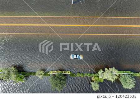 Hurricane flooded car on city street in surrounded with water Florida residential area. Consequences of hurricane Debby natural disaster Hurricane flooded car on city street in surrounded with water Florida residential area. Consequences of hurricane Debby natural disaster 120422638