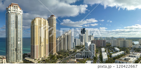 High angle view of Sunny Isles Beach city with expensive highrise hotels and condo buildings on Atlantic ocean shore. American tourism infrastructure in coastal southern Florida 120422667