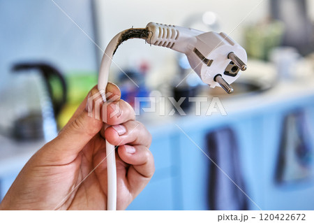 Extension cord burned out when overloaded by powerful electrical appliance. 120422672