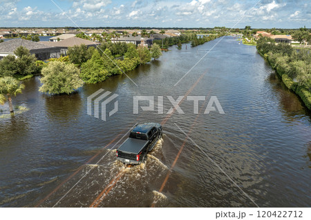 Flooded road with sunken car in surrounded with water Florida residential area. Consequences of hurricane Debby natural disaster Flooded road with sunken car in surrounded with water Florida residential area. Consequences of hurricane Debby natural disaster 120422712