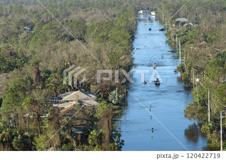 Flooded road in Florida after heavy hurricane rainfall. Aerial view of evacuating cars and surrounded with water houses in suburban residential area 120422719