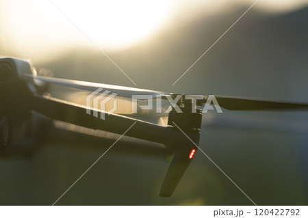 Drone with digital camera and fast rotating propellers flying ta Drone with digital camera and fast rotating propellers flying ta 120422792