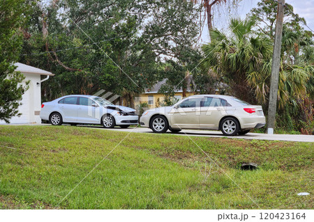 Dented car damaged after traffic accident parked on private home driveway 120423164
