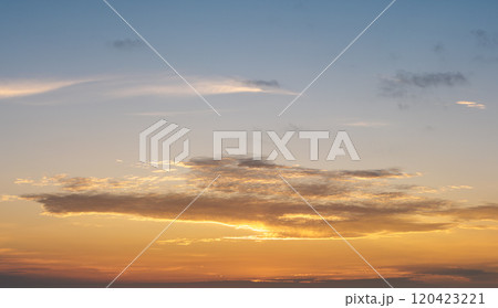 Bright sunset with setting sun behind vivid orange and yellow clouds Bright sunset with setting sun behind vivid orange and yellow clouds 120423221