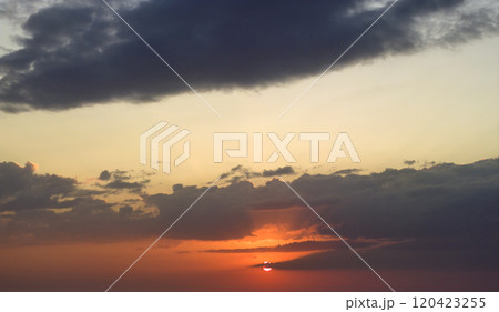 Beautiful sunset sky scenery. Bright colorful orange and yellow clouds on horizon Beautiful sunset sky scenery. Bright colorful orange and yellow clouds on horizon 120423255